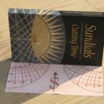 A portable stereographic sundial on the end-flap of a book